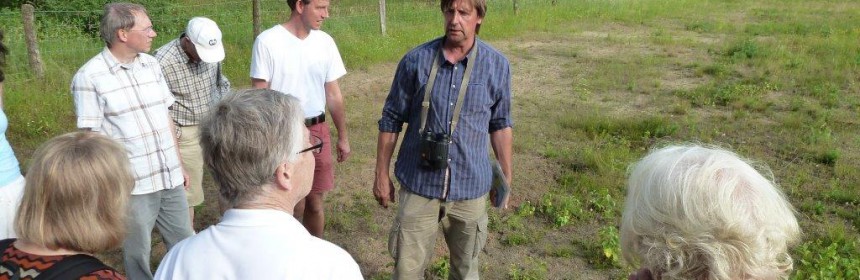 Bernhard Walter zeigt den Exkursionsteilnehmern auf der abgeschobenen Ausgleichsfläche, was sich schon nach wenigen Jahren entwickelt hat.